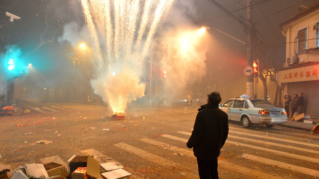 Fireworks explode in a Shanghai street on Thursday, the eve of the Lunar New Year. Setting off firecrackers is meant to ward off evil spirits and bring good luck. But many Chinese say they won't buy firecrackers this year, due to growing worries about air quality. (Image credit: AFP/Getty Images)