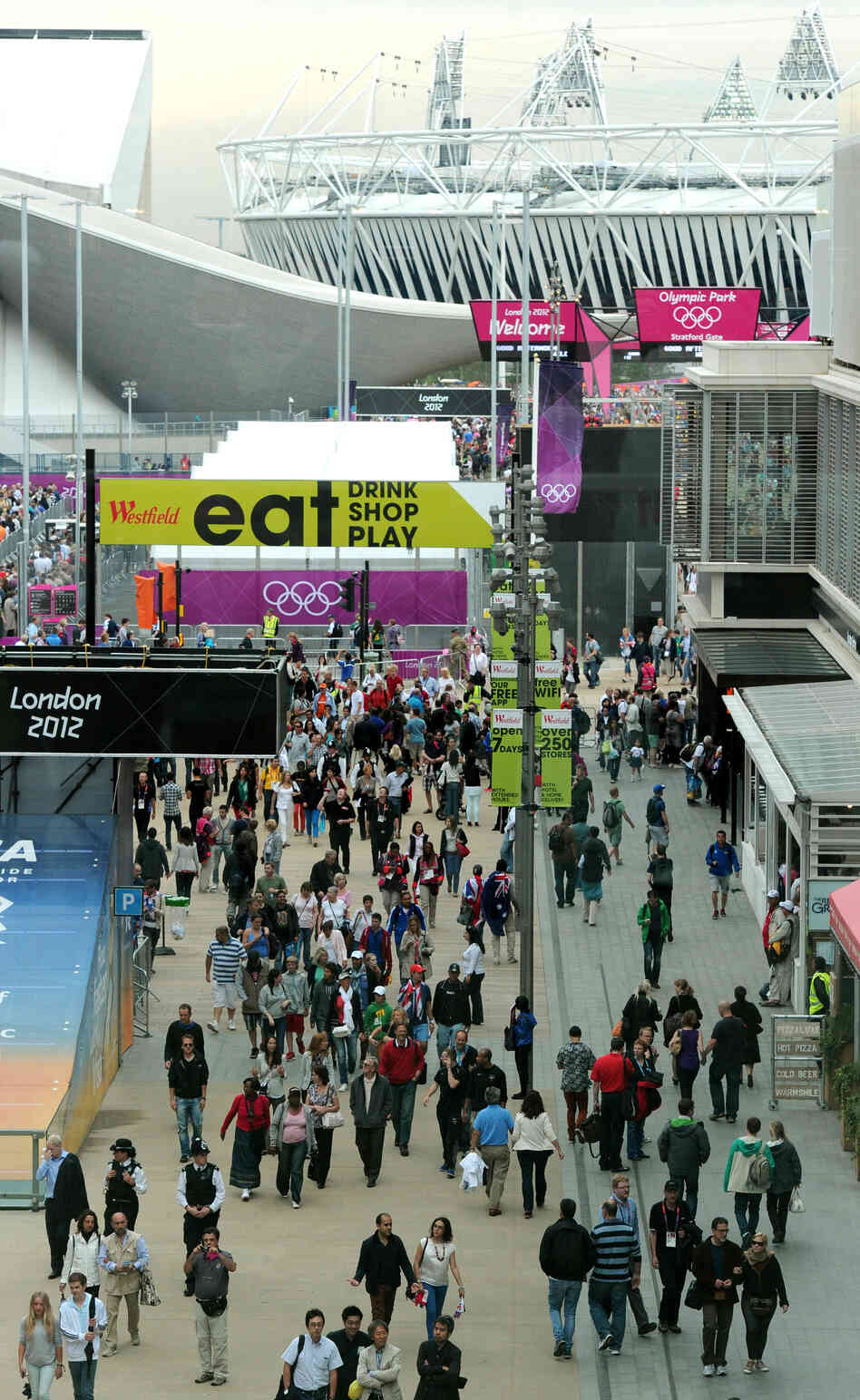 Visitors walk through Westfield Shopping Centre, near London's Olympic Park, on Aug. 1, 2012. The area continues to thrive economically — at least for now. Visitors walk through Westfield Shopping Centre, near London's Olympic Park, on Aug. 1, 2012. The area continues to thrive economically — at least for now.