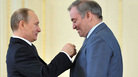 Russian President Vladimir Putin (left) presents the "Hero of Labour" award to conductor Valery Gergiev, head of the Mariinsky Theatre. Russian President Vladimir Putin (left) presents the "Hero of Labour" award to conductor Valery Gergiev, head of the Mariinsky Theatre.