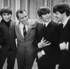 Ed Sullivan smiles while standing with The Beatles on the set of his variety show on Feb. 9, 1964. Ed Sullivan smiles while standing with The Beatles on the set of his variety show on Feb. 9, 1964.