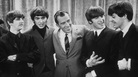 Ed Sullivan smiles while standing with The Beatles on the set of his variety show on Feb. 9, 1964. Ed Sullivan smiles while standing with The Beatles on the set of his variety show on Feb. 9, 1964.
