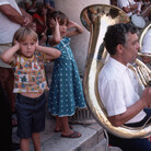 September 1984, Dubrovnik, Croatia --- Small children cover their ears as they stand next to a sousaphone player during a concert played by the Dubrovnik Saturday Band in Dubrovnik, Croatia, Socialist Federal Republic of Yugoslavia. September 1984, Dubrovnik, Croatia --- Small children cover their ears as they stand next to a sousaphone player during a concert played by the Dubrovnik Saturday Band in Dubrovnik, Croatia, Socialist Federal Republic of Yugoslavia.