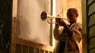 Eleven-year-old Jaron "Bear" Williams practices trumpet before marching in his first Mardi Gras season. The Whole Gritty City follows young student marching bands as they prepare for coveted spots in the New Orleans parade. Eleven-year-old Jaron "Bear" Williams practices trumpet before marching in his first Mardi Gras season. The Whole Gritty City follows young student marching bands as they prepare for coveted spots in the New Orleans parade.