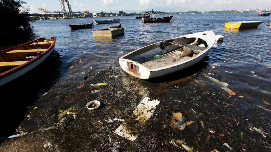 Boats float along the shoreline of the polluted waters of Guanabara Bay on Jan. 21 in Rio. The bay will be the site of sailing events during the Olympics. Local residents recently protested the high level of pollution. Boats float along the shoreline of the polluted waters of Guanabara Bay on Jan. 21 in Rio. The bay will be the site of sailing events during the Olympics. Local residents recently protested the high level of pollution.