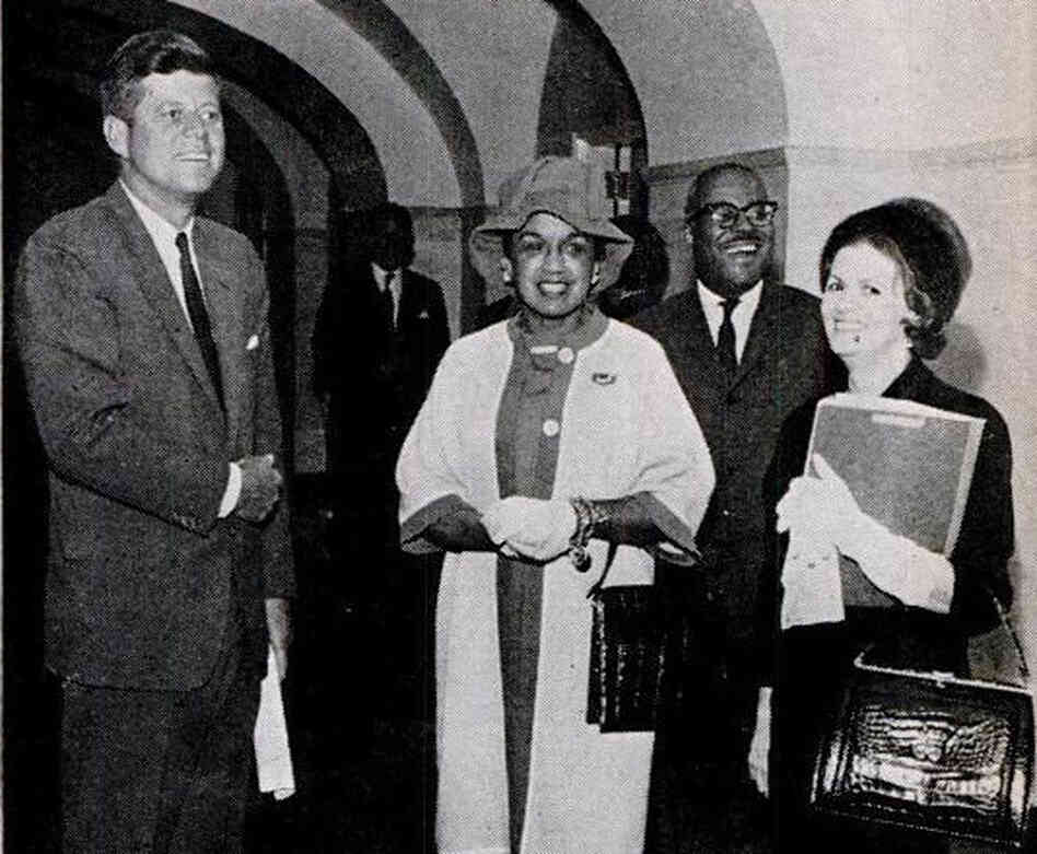 Then-Fashion Fair director Freda DeKnight (center) stands with President John F. Kennedy when the models visited the White House. The photo was featured in the Oct. 26, 1961, issue of Jet Magazine. Then-Fashion Fair director Freda DeKnight (center) stands with President John F. Kennedy when the models visited the White House. The photo was featured in the Oct. 26, 1961, issue of Jet Magazine.