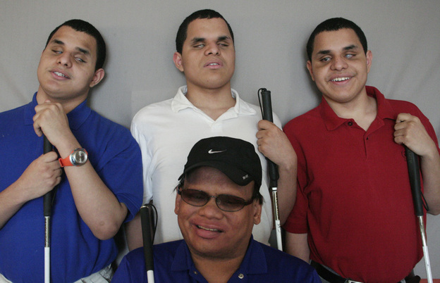 The lives of Leo, Nick and Steven Argel (from left) changed the day Ollie Cantos knocked on their door. (Image credit: StoryCorps)