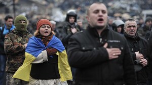 Anti-government protesters sing the Ukrainian national anthem at Independence Square in central Kiev on Saturday.