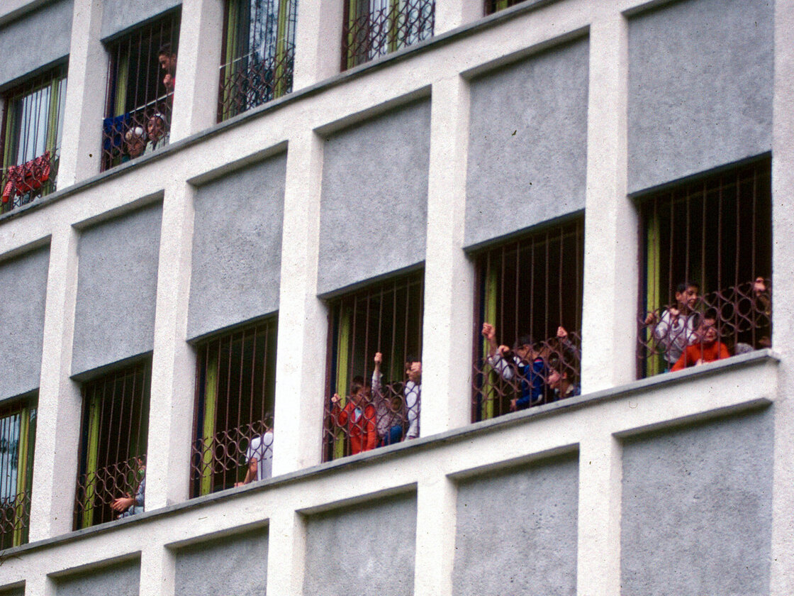 Children reach out from the windows of the orphanage in Sighetu Marmatiei in 1992.