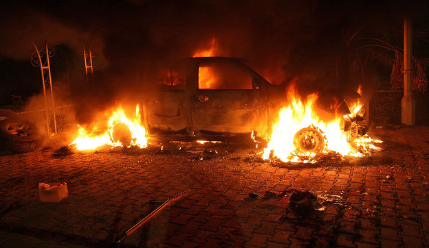 A vehicle inside the U.S. Consulate compound in Benghazi is engulfed in flames after an attack on Sept. 11, 2012. 'There is no evidence whatsoever that al-Qaida or any group linked to al-Qaida played a role in organizing or leading the attack,' says New York Times correspondent David Kirkpatrick. (Image credit: AFP/Getty Images)