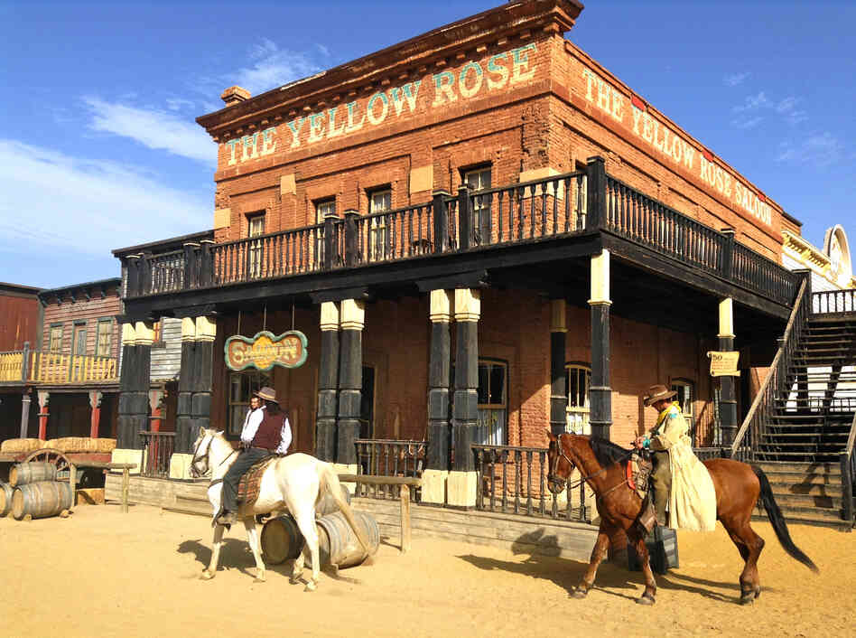 Actors roam in front of the Yellow Rose Saloon at the Oasys Theme Park, a tourist attraction built from abandoned film sets left over from the Spaghetti Westerns that were filmed in southern Spain's Tabernas Desert in the 1960s and 70s. Actors roam in front of the Yellow Rose Saloon at the Oasys Theme Park, a tourist attraction built from abandoned film sets left over from the Spaghetti Westerns that were filmed in southern Spain's Tabernas Desert in the 1960s and 70s.
