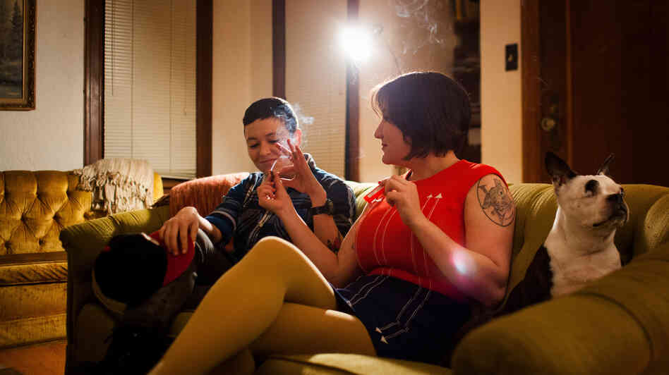 Cohen passes a joint to her friend Mika Loudon at her home in Seattle, Wash. Cohen passes a joint to her friend Mika Loudon at her home in Seattle, Wash.