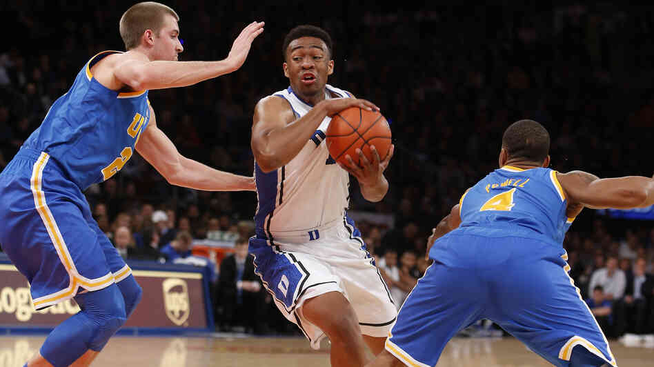 Duke's Jabari Parker weaves his way through UCLA players during a December game in New York. Duke's Jabari Parker weaves his way through UCLA players during a December game in New York.