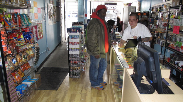 Communications store owner Donny Seto (right) says other business owners shouldn't be so hesitant to set up in the Congress Heights neighborhood of Washington, D.C. (Image credit: NPR)