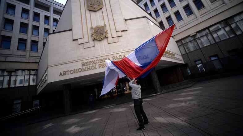A Russian flag blows outside the entrance of Crimea's parliament building in Simferopol on Thursday. Crimeans vote Sunday on whether they want to join Russia, though the international community says it will not recognize the ballot.