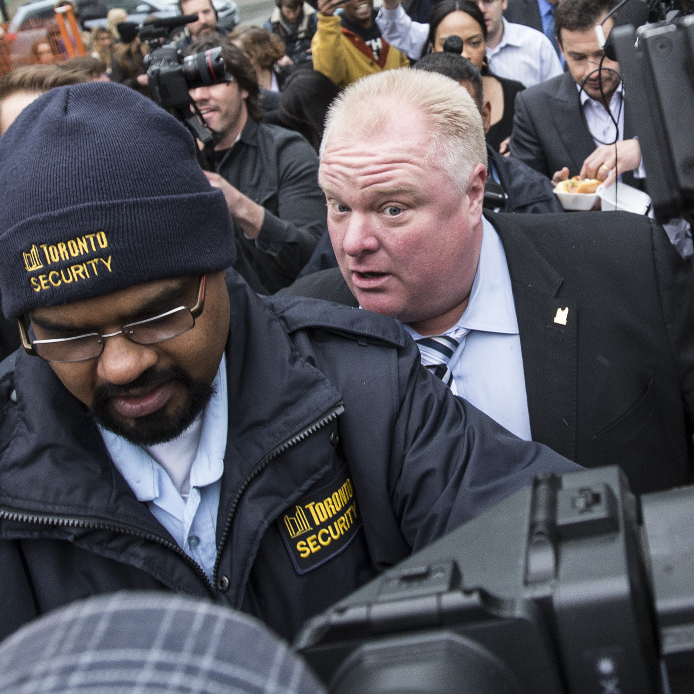 Toronto Mayor Rob Ford walks to City Hall in a media scrum in Toronto, on Wednesday.