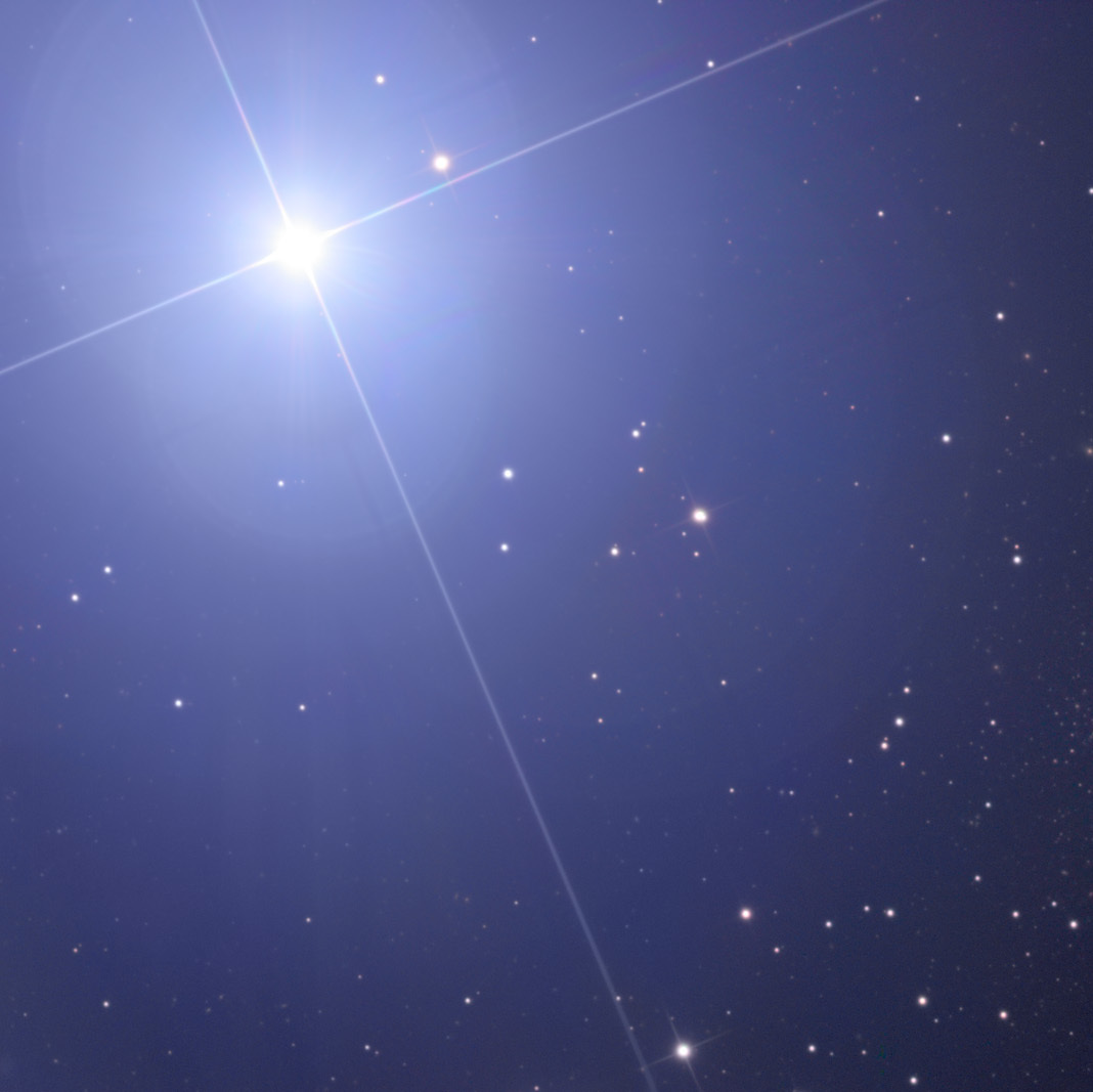 Regulus, the bright star on the upper left, is part of a multiple star system, with a close companion double star visible to the upper right of the young main sequence star.