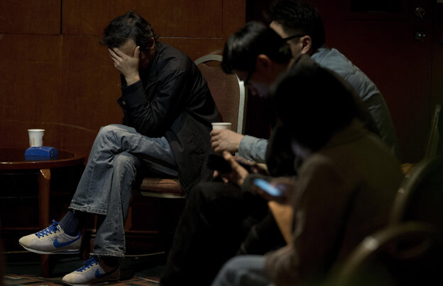 Relatives of the Chinese passengers aboard the missing Malaysia Airlines Flight 370 wait for the latest news of the plane at a Beijing hotel on Thursday.