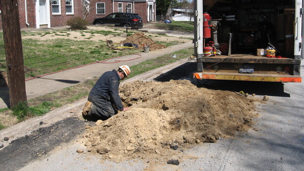 A Philadelphia Gas Works employee replaces old steel and cast-iron pipes with new plastic pipes that are less likely to leak. (Image credit: NPR)