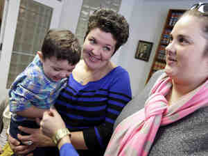 Nicole Yorksmith (left) holds her son while standing with her partner, Pam Yorksmith. They were among four legally married couples who filed a federal civil rights lawsuit seeking to compel Ohio to recognize same-sex marriages on birth certificates. Nicole Yorksmith (left) holds her son while standing with her partner, Pam Yorksmith. They were among four legally married couples who filed a federal civil rights lawsuit seeking to compel Ohio to recognize same-sex marriages on birth certificates.