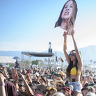 A fan holds up a giant mask of Este Haim from the rock band HAIM at Coachella. A fan holds up a giant mask of Este Haim from the rock band HAIM at Coachella.