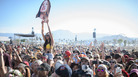 A fan holds up a giant mask of Este Haim from the rock band HAIM at Coachella. A fan holds up a giant mask of Este Haim from the rock band HAIM at Coachella.