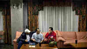Abu Ghassan (from left), Hassan and Sobhy sit in the lobby of a hotel in Athens, Greece, that blocks out at least 40 rooms each month for Syrian refugees and gives them a discount, on Feb. 11. Though the Syrians have a safe haven at the hotel, Greece as a whole has not been as welcoming.