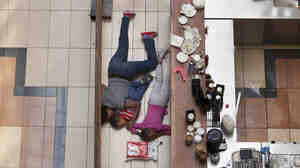 Tyler Hicks took this photo of a woman sheltering her children on the floor of a cafe at the Westgate Mall during an attack by militants in Nairobi on Sept. 21, 2013. The woman later contacted Hicks and told him she kept her kids quiet and still by singing along to songs that were playing on the mall loudspeakers.