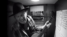Neil Young in a recording booth, tracking a cover of Bert Jansch's "Needle Of Death." Neil Young in a recording booth, tracking a cover of Bert Jansch's "Needle Of Death."