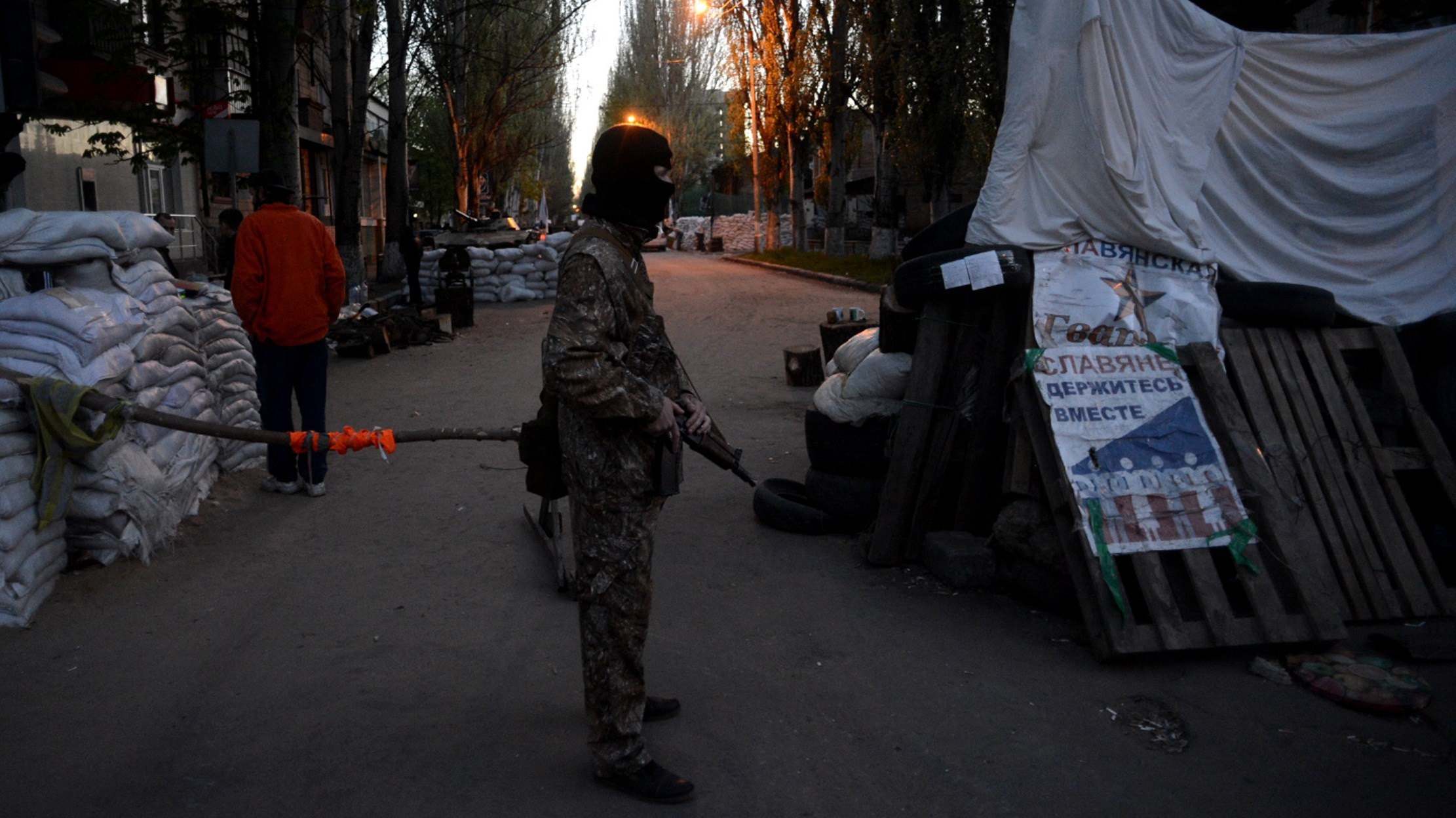 A Pro-Russian separatist stands guard outside the security building in the eastern Ukrainian city of Slavyansk on Saturday. A Pro-Russian separatist stands guard outside the security building in the eastern Ukrainian city of Slavyansk on Saturday.