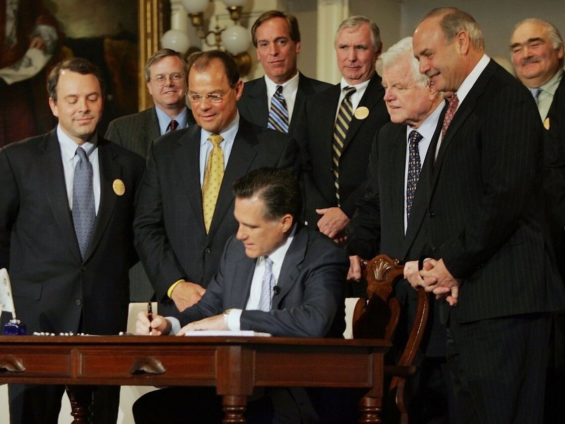 Massachusetts Gov. Mitt Romney signed a health care reform bill during an April 12, 2006, ceremony at Faneuil Hall in Boston. The bill made Massachusetts the first state in the country to require that all residents have health insurance.