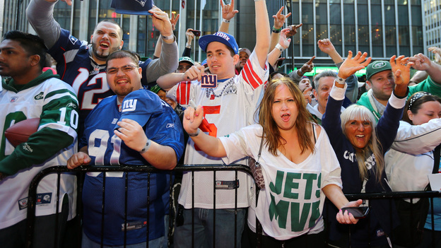 Fans outside Radio City Music Hall show support for their teams during the first round of the 2013 NFL Draft on April 25, 2013, in New York. (Image credit: Getty Images)