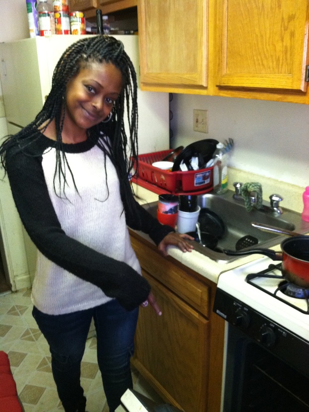 Toni Smart points to the oven that she uses to heat her one-bedroom apartment, which has no heat. Smart says she and her kids stayed in homeless shelters a few years ago. She says she'd rather be without heat than in the shelter. (Image credit: NPR)