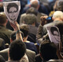 Participants hold up images of former NSA analyst Edward Snowden at an April conference on the future of Internet governance in Sao Paulo, Brazil.