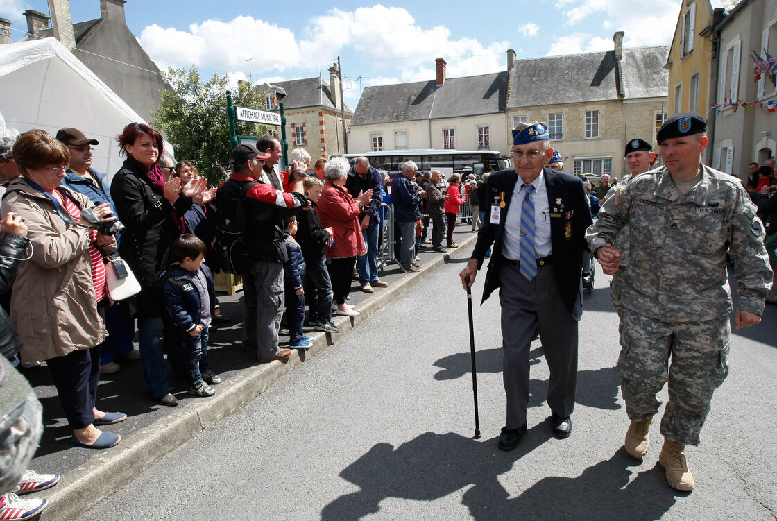 U.S. World War II veteran Arden C. Earll, 89, of Erie, Penn., landed on Omaha Beach on June 6, 1944, with the 29th Infantry Division regiment. A crowd applauds as he arrives at a ceremony in honor of the division, in La Cambe, France, as part of the commemoration of the 70th D-Day anniversary on Wednesday. U.S. World War II veteran Arden C. Earll, 89, of Erie, Penn., landed on Omaha Beach on June 6, 1944, with the 29th Infantry Division regiment. A crowd applauds as he arrives at a ceremony in honor of the division, in La Cambe, France, as part of the commemoration of the 70th D-Day anniversary on Wednesday.