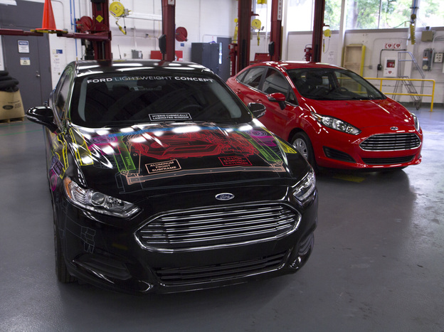 Ford says it cut the weight of its concept Fusion (left) by nearly 25 percent, matching the weight of a Ford Fiesta (right). (Image credit: Ford)