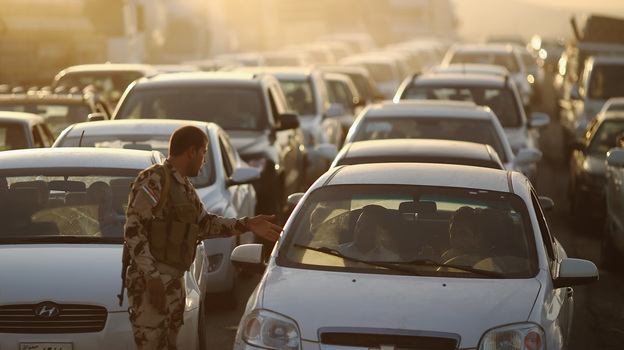 Cars pack a Kurdish checkpoint as residents flee Mosul in northern Iraq. The city was overrun by Islamic militants last week. (Image credit: Getty Images)