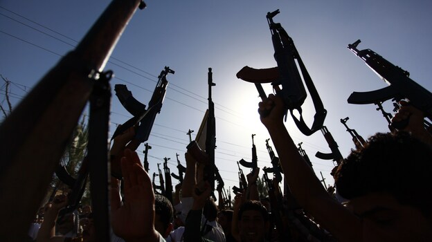 Iraqi Shiite tribesmen show their enthusiasm Tuesday for joining Iraqi security forces in the fight against Islamist militants who have taken over several northern Iraqi cities. (Image credit: AFP/Getty Images)