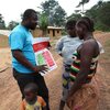 A UNICEF field worker talks to villagers in Liberia's Foya District about how to prevent Ebola disease. A UNICEF field worker talks to villagers in Liberia's Foya District about how to prevent Ebola disease.