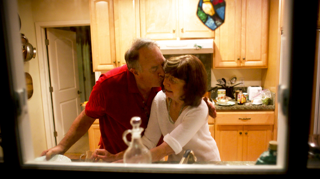Rick and Marianne wash dishes together. She no longer remembers that he is her husband. (Capital Public Radio)