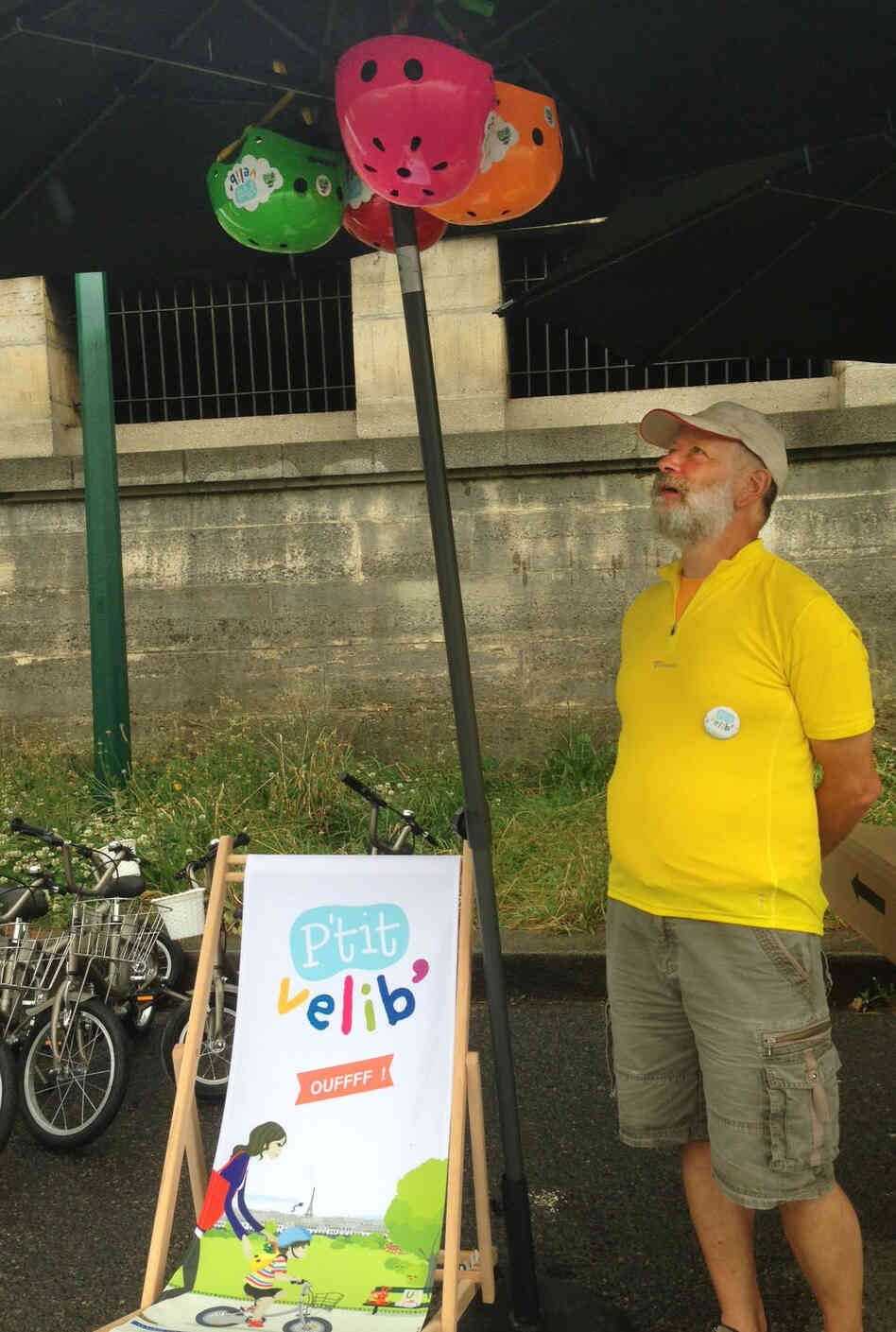 Joel Sick displays colorful helmets for rent at his P'tit Velib stand. His bikes come in four different sizes for children ages 2-8. Joel Sick displays colorful helmets for rent at his P'tit Velib stand. His bikes come in four different sizes for children ages 2-8.