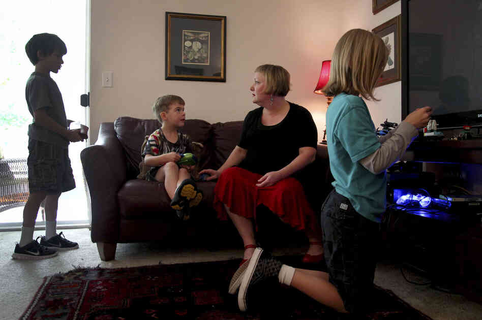 Moritz plays with her sons (from left) Elliot, 8, Ariel, 6, and Aidan in their apartment. The children also have had health problems since their father's accident. Moritz plays with her sons (from left) Elliot, 8, Ariel, 6, and Aidan in their apartment. The children also have had health problems since their father's accident.
