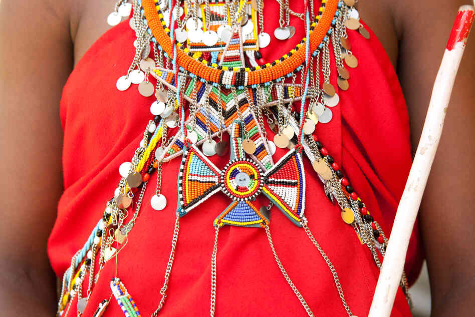 The Maasai wear vibrant colored shukas, or robes, adorned with elaborate beaded jewelry made by the women. The Maasai wear vibrant colored shukas, or robes, adorned with elaborate beaded jewelry made by the women.