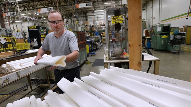 A worker stacks traffic safety poles at Pexco's manufacturing center in Fife, Wash. The small company ships products all over the world, with the help of federal insurance from the Export-Import Bank. (Image credit: MCT/Landov)