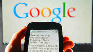 A Google search removal request is displayed on the screen of a smartphone in London. The company says it has received more than 70,000 takedown requests following a European court ruling.