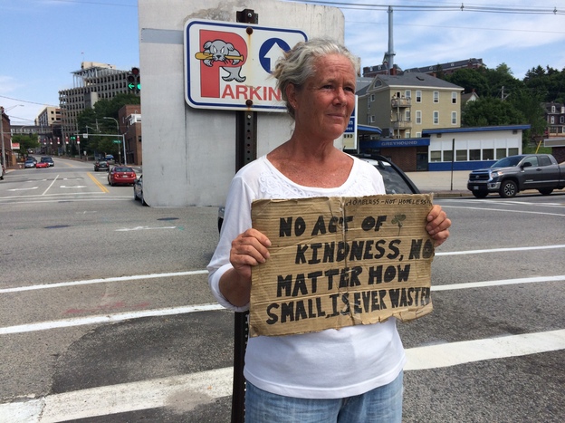 Susan St. Amour panhandles on a median in Portland, Maine. The city tried to ban loitering on medians last year, but a judge found the law unconstitutional. (Image credit: Caroline Losneck)