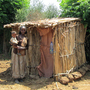 An Ethiopian woman and her child stand next to an Arborloo latrine. An Ethiopian woman and her child stand next to an Arborloo latrine.
