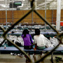 Two young girls, part of the wave of unaccompanied children who've illegally entered the U.S., watch a soccer match at the Customs and Border Protection Nogales Placement Center in Arizona. Two young girls, part of the wave of unaccompanied children who've illegally entered the U.S., watch a soccer match at the Customs and Border Protection Nogales Placement Center in Arizona.