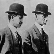 Brothers and aviation pioneers Orville and Wilbur Wright walk together in 1910.