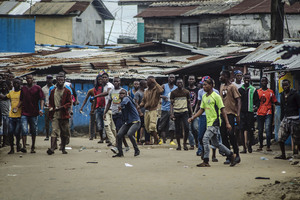 Angry protesters hurl rocks at the soldiers and policemen enforcing the quarantine.
