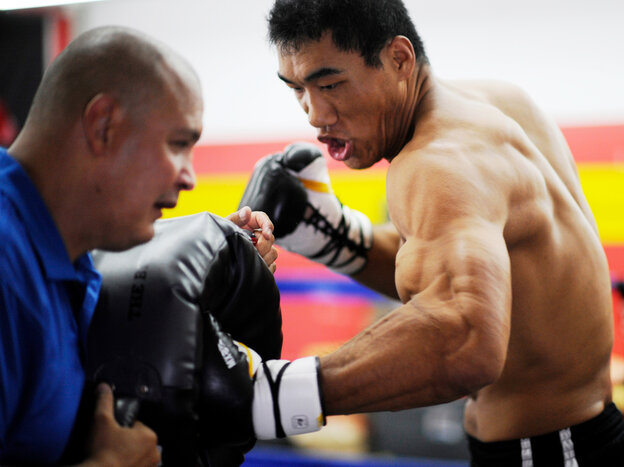 Taishan Dong works with coach John Bray at the Glendale Fighting Club, north of Los Angeles. At 6 feet 11 inches tall, Taishan towers over opponents.